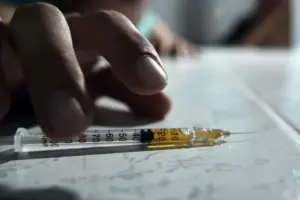 Syringe with heroin on a table highlighting the dangers of opioid addiction and the importance of choosing professional heroin rehab treatment