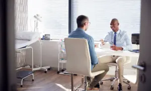 Doctor consulting patient about opioid withdrawal symptoms and timeline during medical evaluation