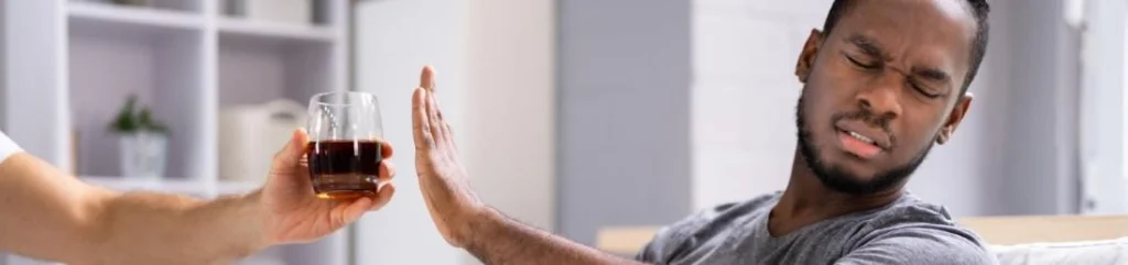 Los Angeles Alcohol Rehab Man with pain in his face refuses an alcoholic drink