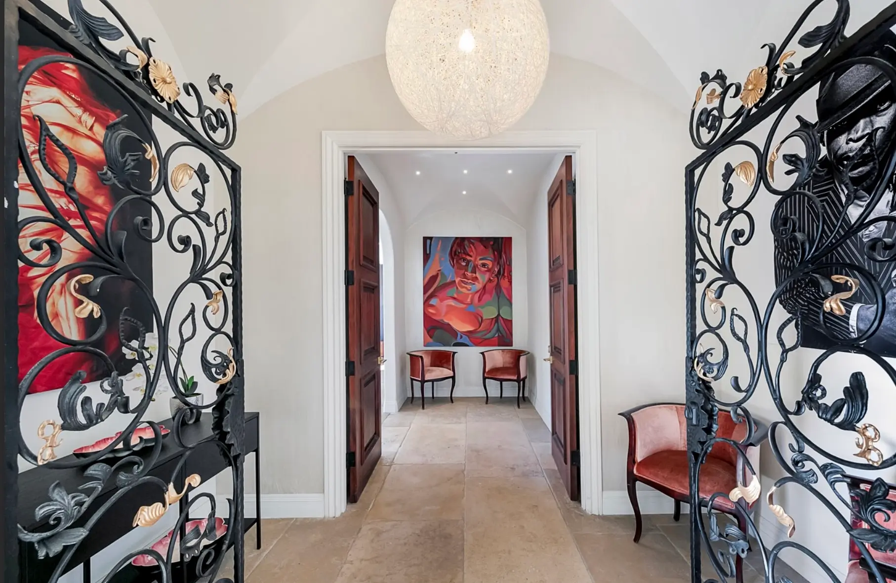 Grand Entrance at Los Angeles Luxury Mental Health Retreat Elegant wrought iron doors opening into a luxury Los Angeles mental health retreat with modern art and refined interior design