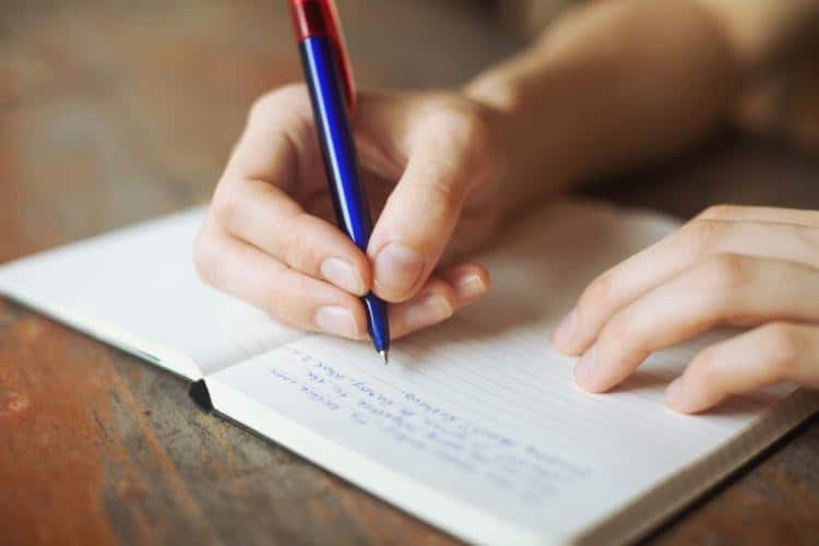 recovery plan Person writes down a recovery plan in their journal