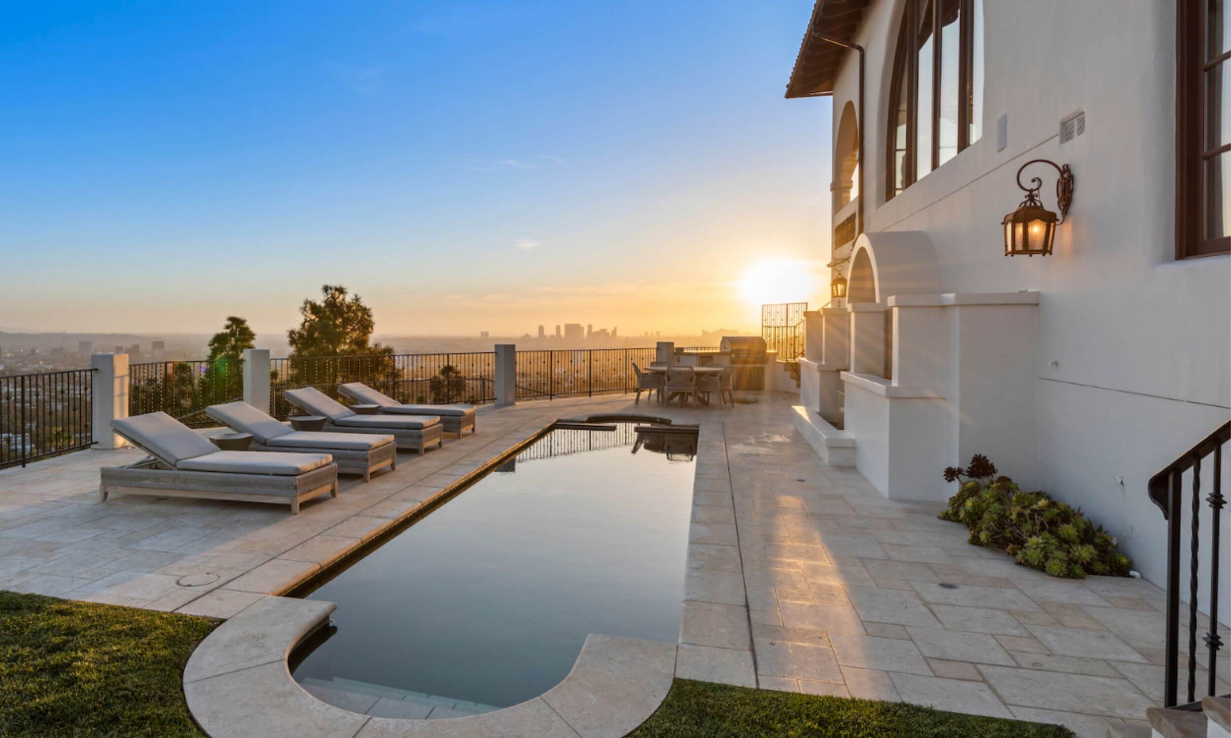 The image depicts a serene resort-style setting featuring a sparkling swimming pool surrounded by lush palm trees and comfortable lounge chairs, creating a peaceful atmosphere ideal for relaxation and reflection. This tranquil environment could serve as a supportive backdrop for those on their recovery journey from substance abuse or addiction treatment, emphasizing the importance of a strong support system during the treatment process.